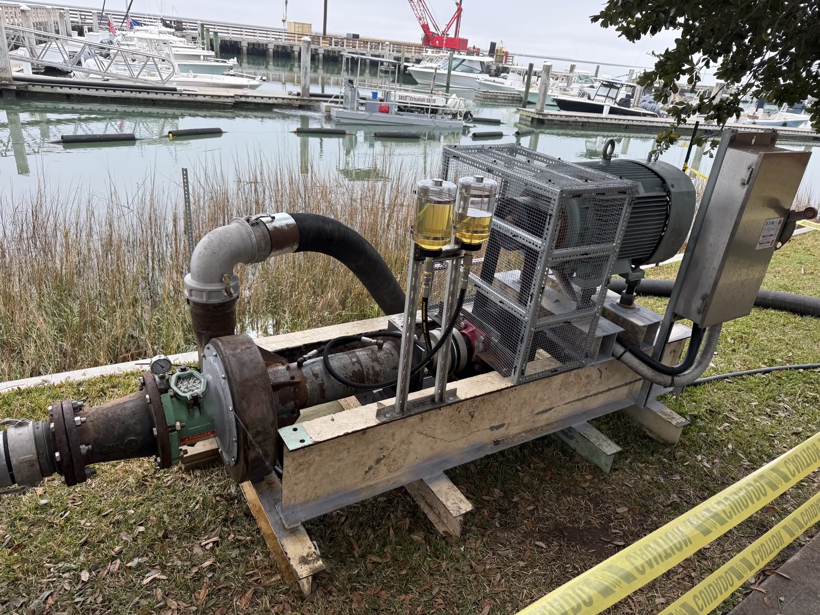 Booster pump system that extends pumping distance on long-reach dredging projects